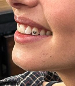 Close-up of tooth gem application at Take Pride Barbershop in Portland OR