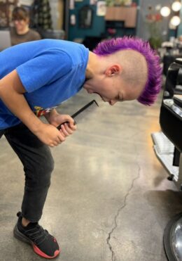 Bold purple mohawk styled by Kenzy at Take Pride Barbershop in Portland.