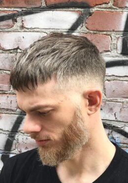 Barber Kenzy in Portland creating a textured fade with beard trim at Take Pride Barbershop.