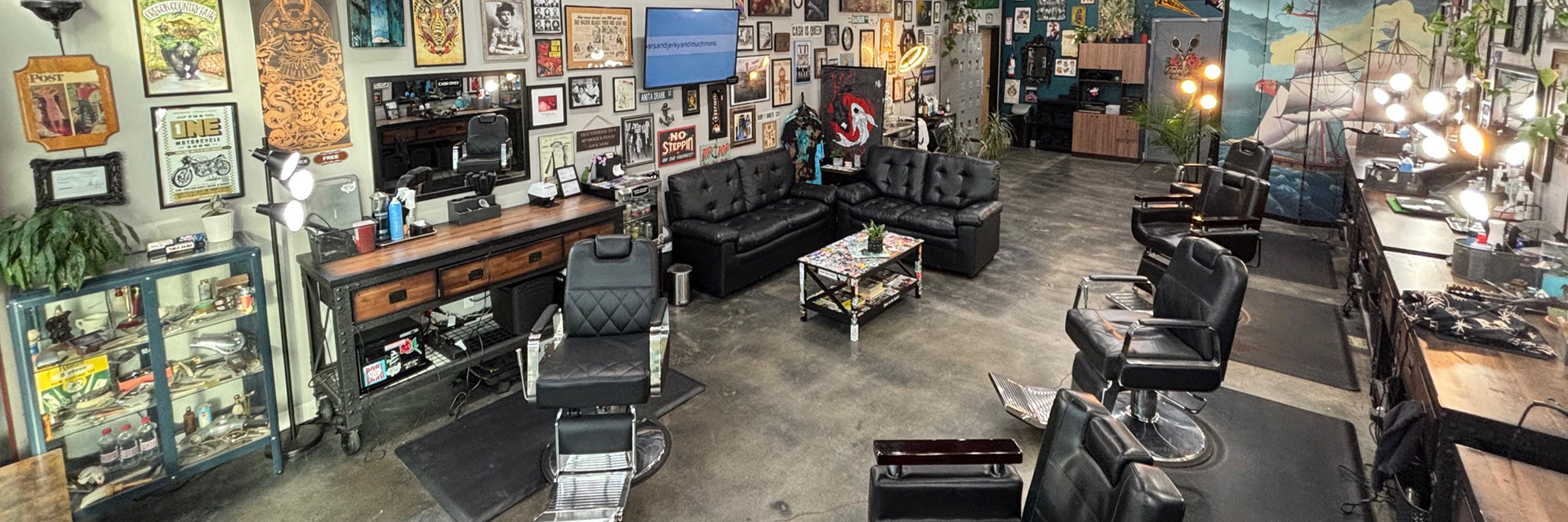 Inside Take Pride Barbershop in Portland, Oregon featuring barber chairs, artwork, and lounge area